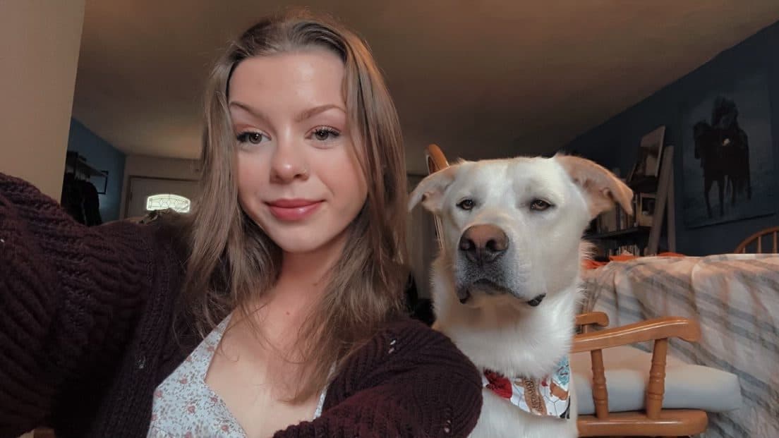 Nicole Damitio with her white Labrador